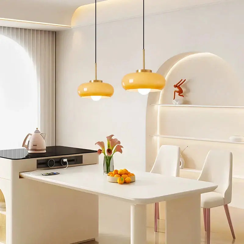 Sleek amber glass and copper pendant light for kitchens
