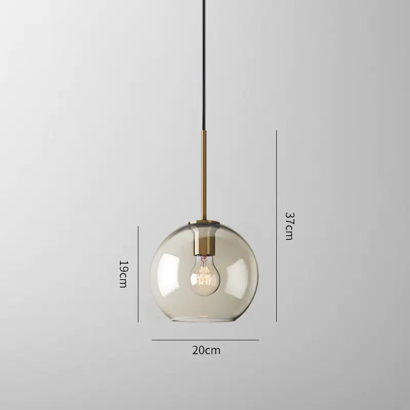 Modern smoked glass pendant lights with brass accents for kitchen island