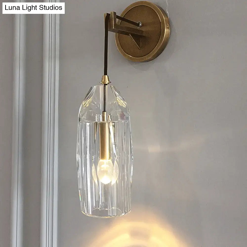 Modern single light brass wall sconce with clear crystal for bedroom