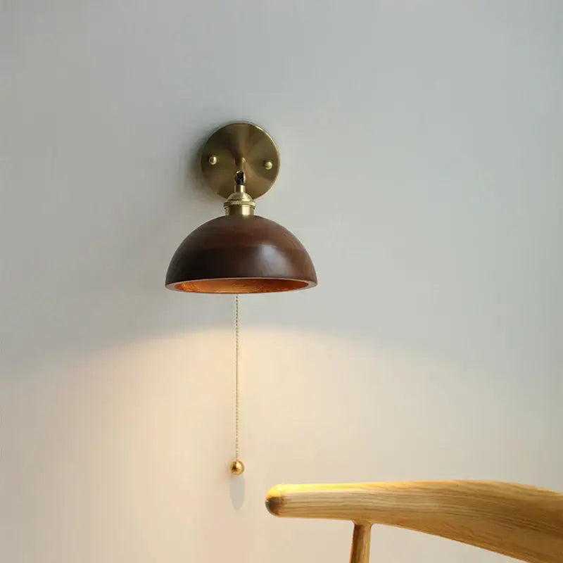 Walnut and brass wall sconce with pull chain switch bedroom light